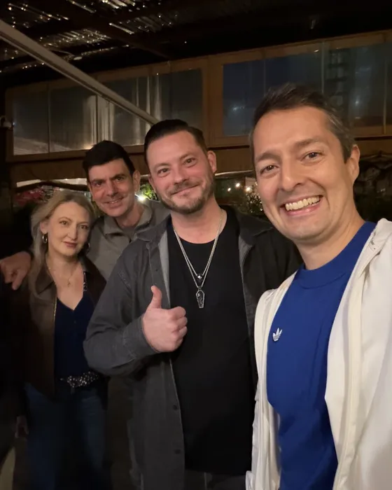 Four Rounds guests smiling for a group selfie at night